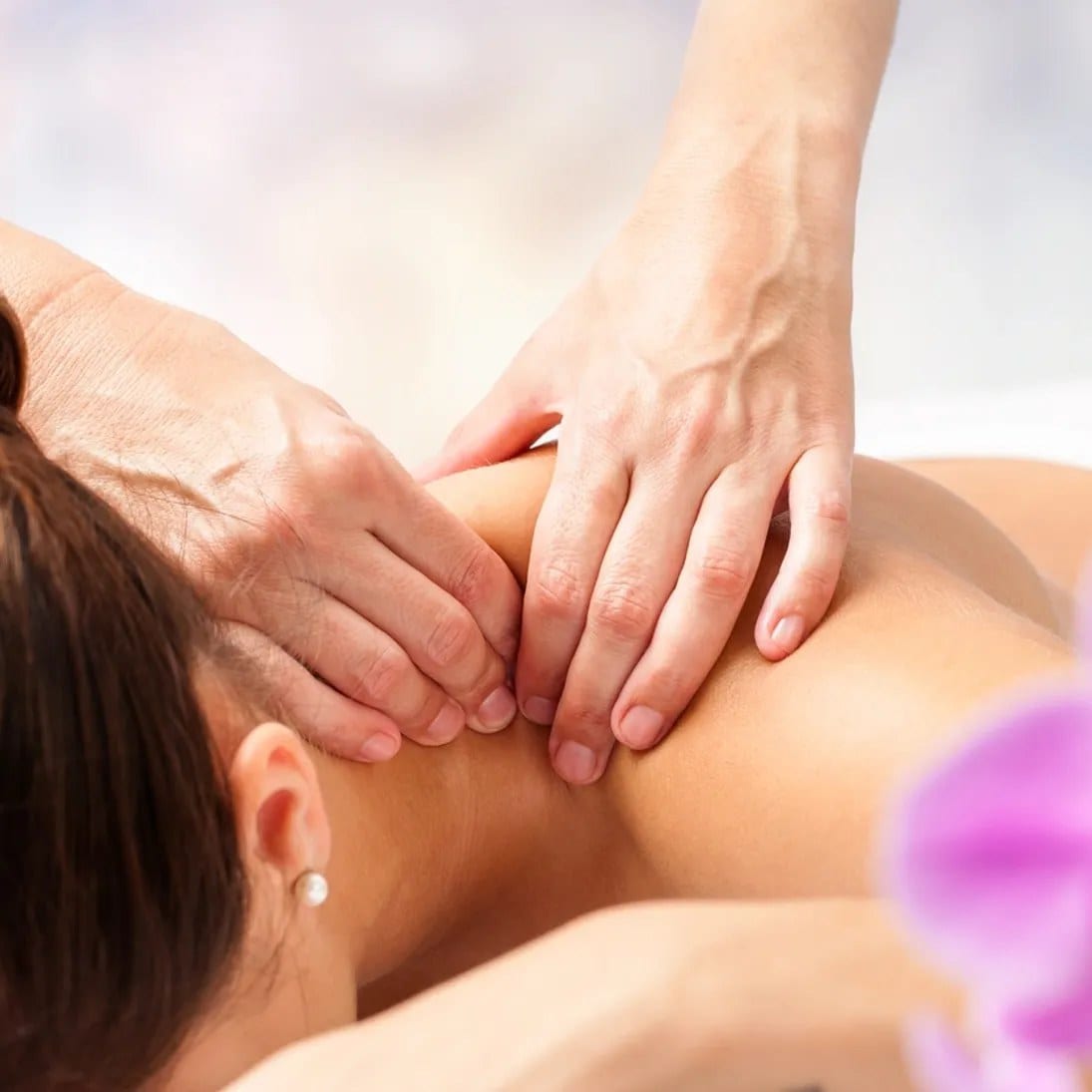 A therapist working on a client's neck and shoulders
